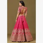 SEASONS-RANI PINK CLASSIC BRIDAL LEHENGA SET WITH ALL OVER PATTERNED HAND EMBROIDERY PAIRED WITH A MATCHING DUPATTA AND FLORAL EMBROIDERED DETAILS.